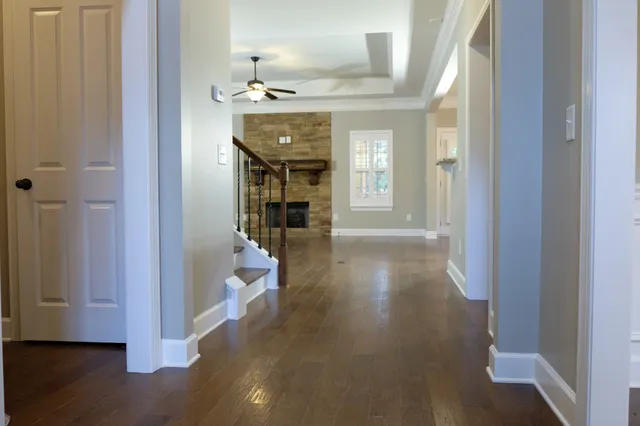 a view of a hallway view with wooden floor and staircase