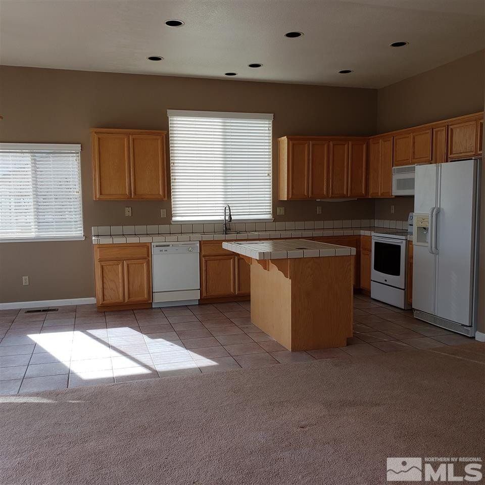 986 University Place Reno, NV 89512 - Photo 12 of 25 a kitchen with stainless steel appliances granite countertop a stove a sink and a refrigerator