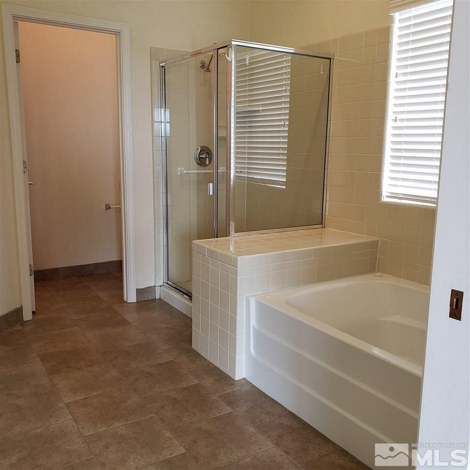 986 University Place Reno, NV 89512 - Photo 18 of 25 a bathroom with a bathtub and a shower