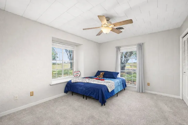 a bedroom with a bed and a window