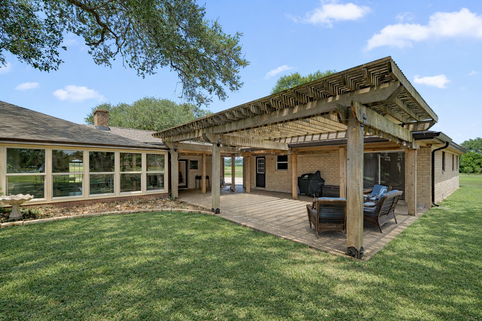 3148 FM 333 Road Garwood, TX 77442 - Photo 24 of 39 a view of a house with a large window and a yard
