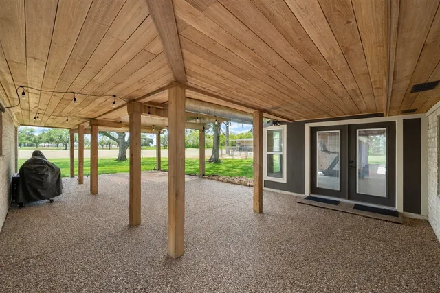 a view of a porch with furniture and floor to ceiling window