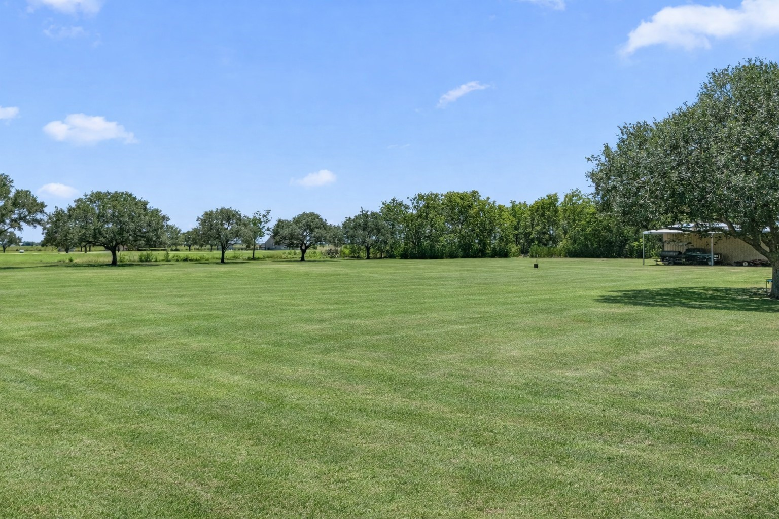 3148 FM 333 Road Garwood, TX 77442 - Photo 39 of 39 a view of a grassy field with trees in the background
