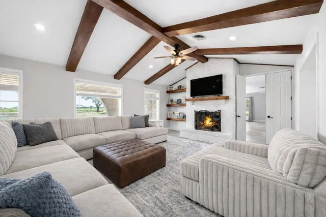a living room with furniture fireplace and a flat screen tv
