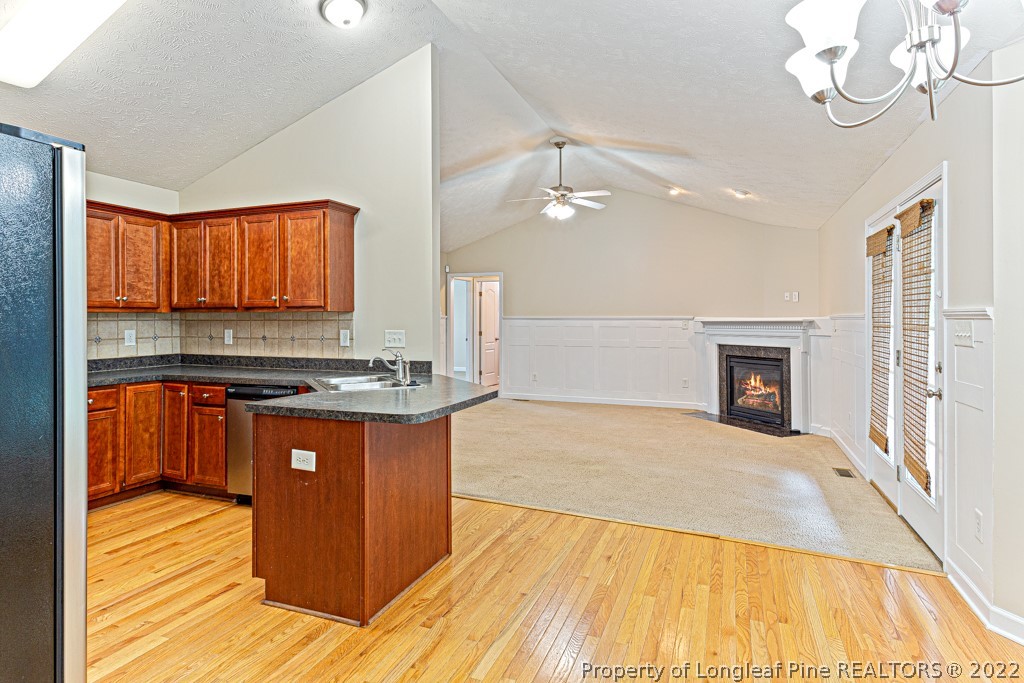 75 Hayden Lane Cameron, NC 28326 - Photo 11 of 35 a large kitchen with stainless steel appliances granite countertop a stove and a wooden floors