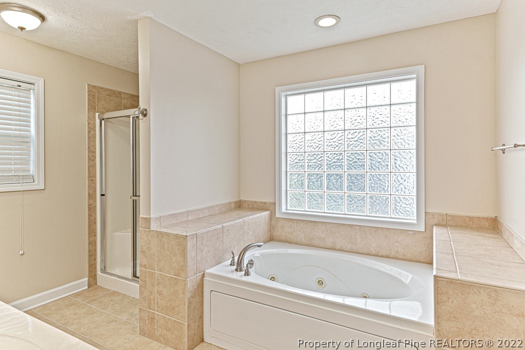 75 Hayden Lane Cameron, NC 28326 - Photo 18 of 35 a bathroom with a bathtub a shower and a sink