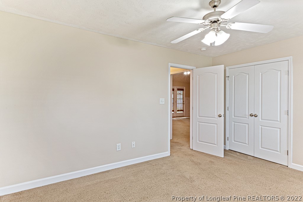 75 Hayden Lane Cameron, NC 28326 - Photo 21 of 35 an empty room with closet and a ceiling fan