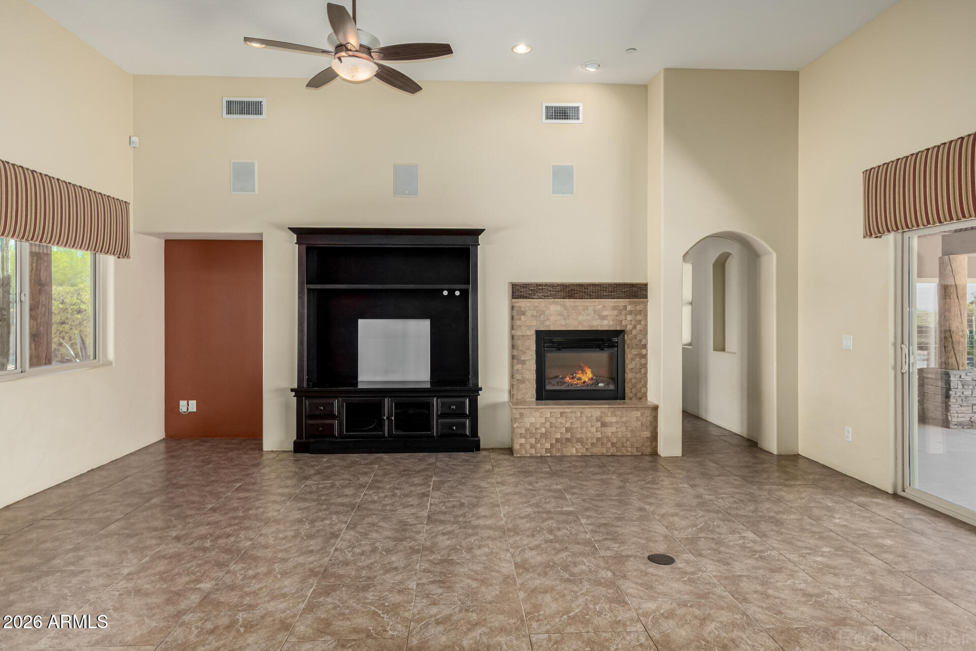 6033 East Lone Mountain Road Cave Creek, AZ 85331 - Photo 16 of 77 a view of an empty room with a fireplace and a window