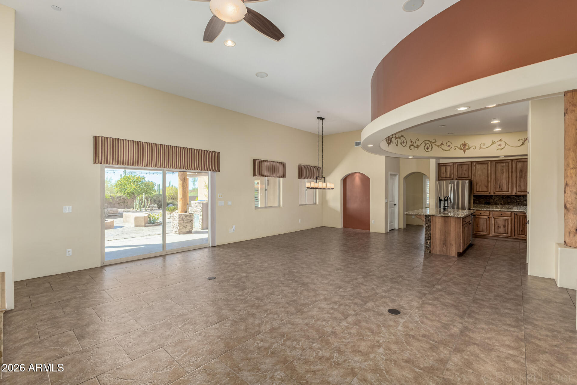 6033 East Lone Mountain Road Cave Creek, AZ 85331 - Photo 17 of 77 a view of a livingroom with wooden floor and a ceiling fan