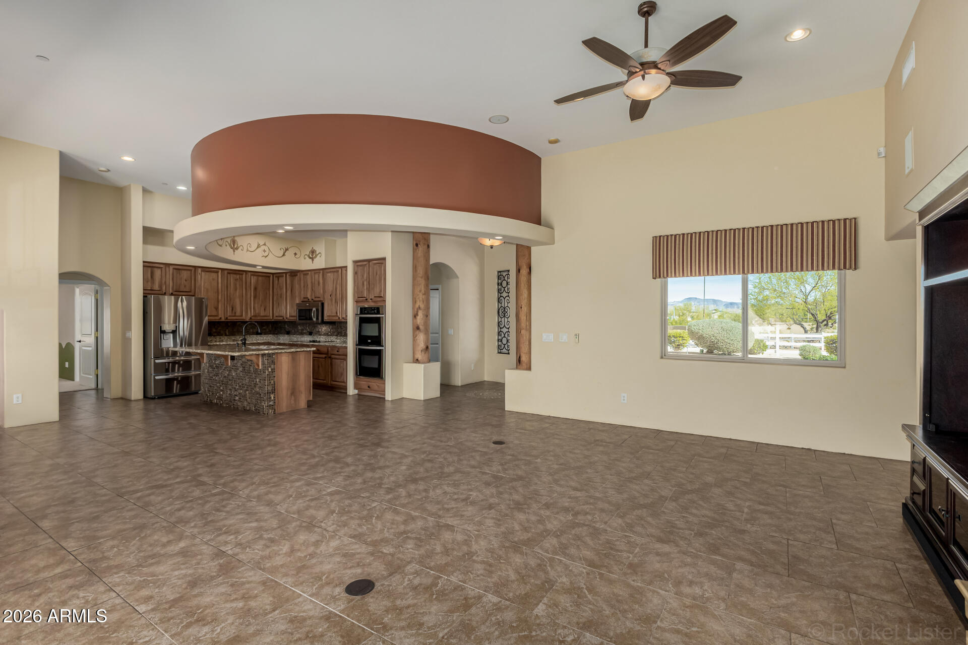 6033 East Lone Mountain Road Cave Creek, AZ 85331 - Photo 18 of 77 a view of a livingroom with a ceiling fan and a window