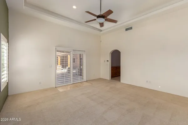 a view of a yard with wooden fence