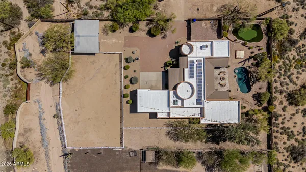 a kitchen with stainless steel appliances granite countertop a refrigerator a stove and white cabinets with wooden floor