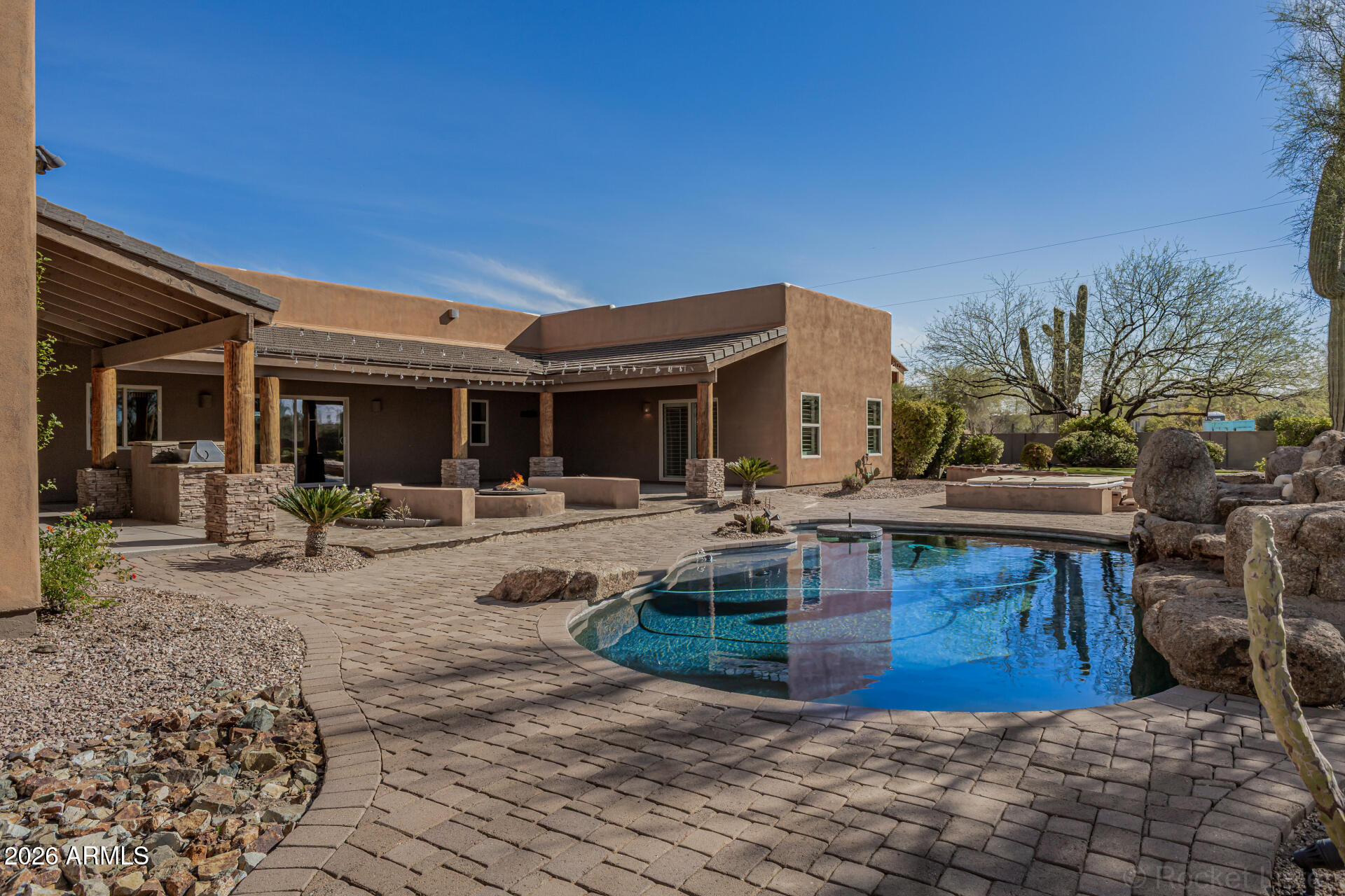 6033 East Lone Mountain Road Cave Creek, AZ 85331 - Photo 59 of 77 a view of a house with swimming pool and sitting area