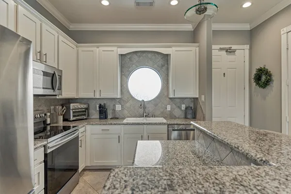 a view of a chairs and table in patio with a lake view