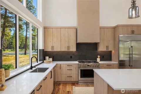 a kitchen with a stove a sink and a refrigerator