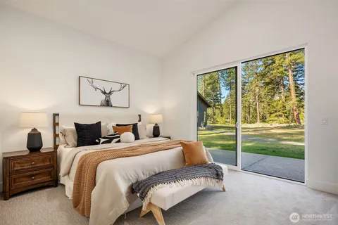 a bedroom with a bed and a large window