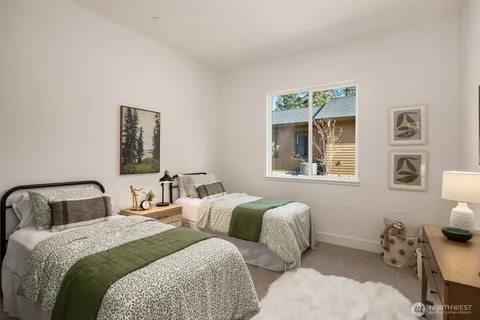 a bedroom with two beds and painting on the wall