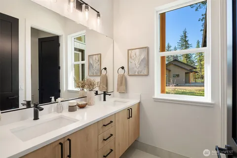 a bathroom with 2 sink and a mirror