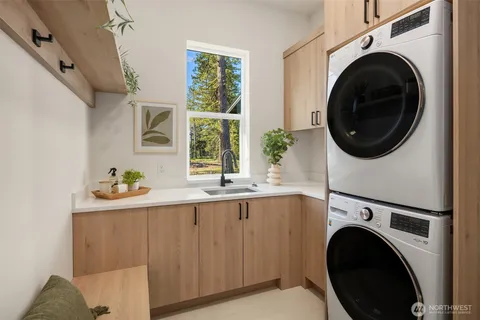 a utility room with sink dryer and washer