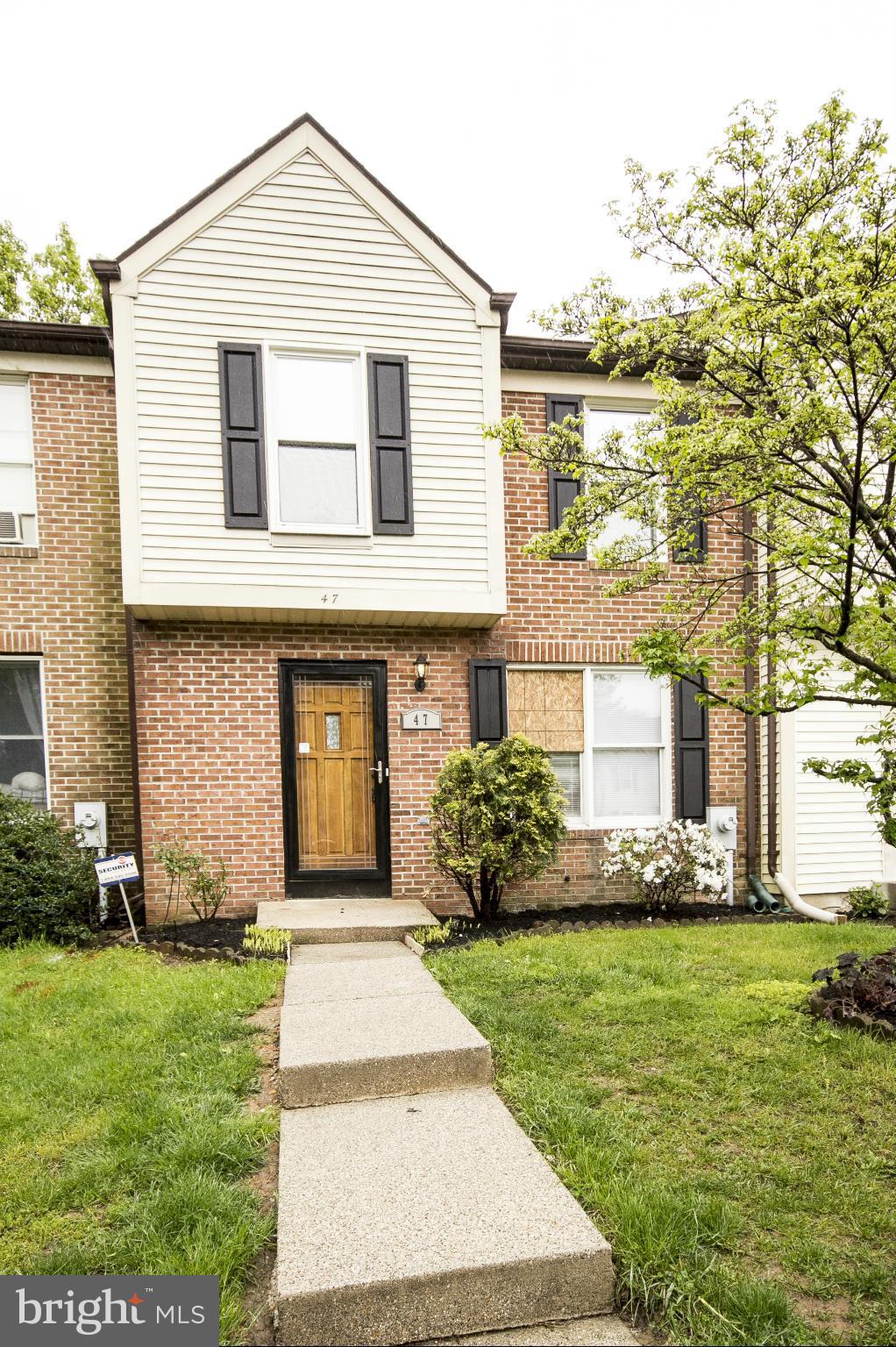 47 Robin Ridge Court Baltimore, MD 21234 - Photo 2 of 30 a front view of a house with a garden and plants