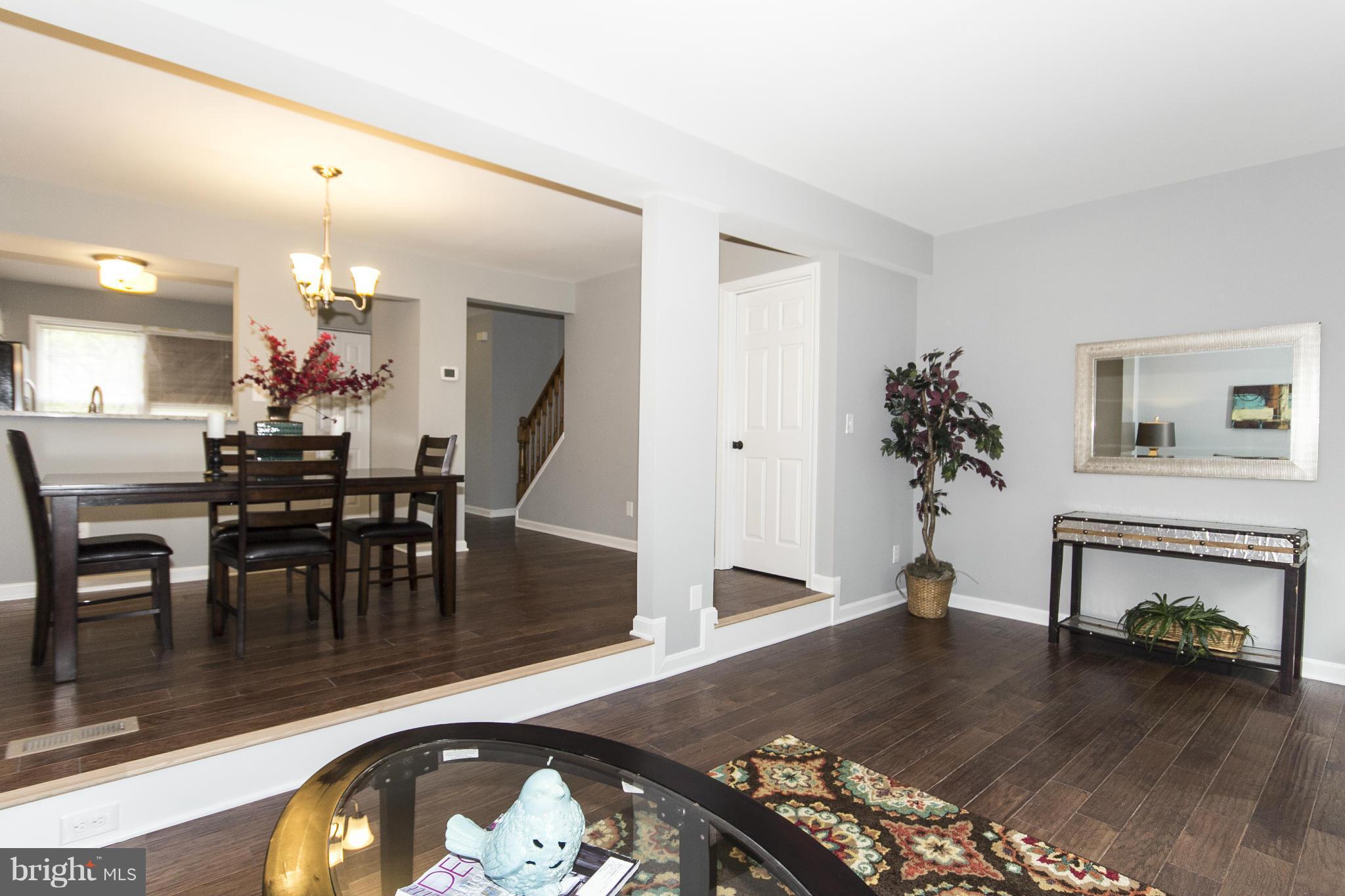 47 Robin Ridge Court Baltimore, MD 21234 - Photo 12 of 30 a dining room with furniture potted plants and wooden floor