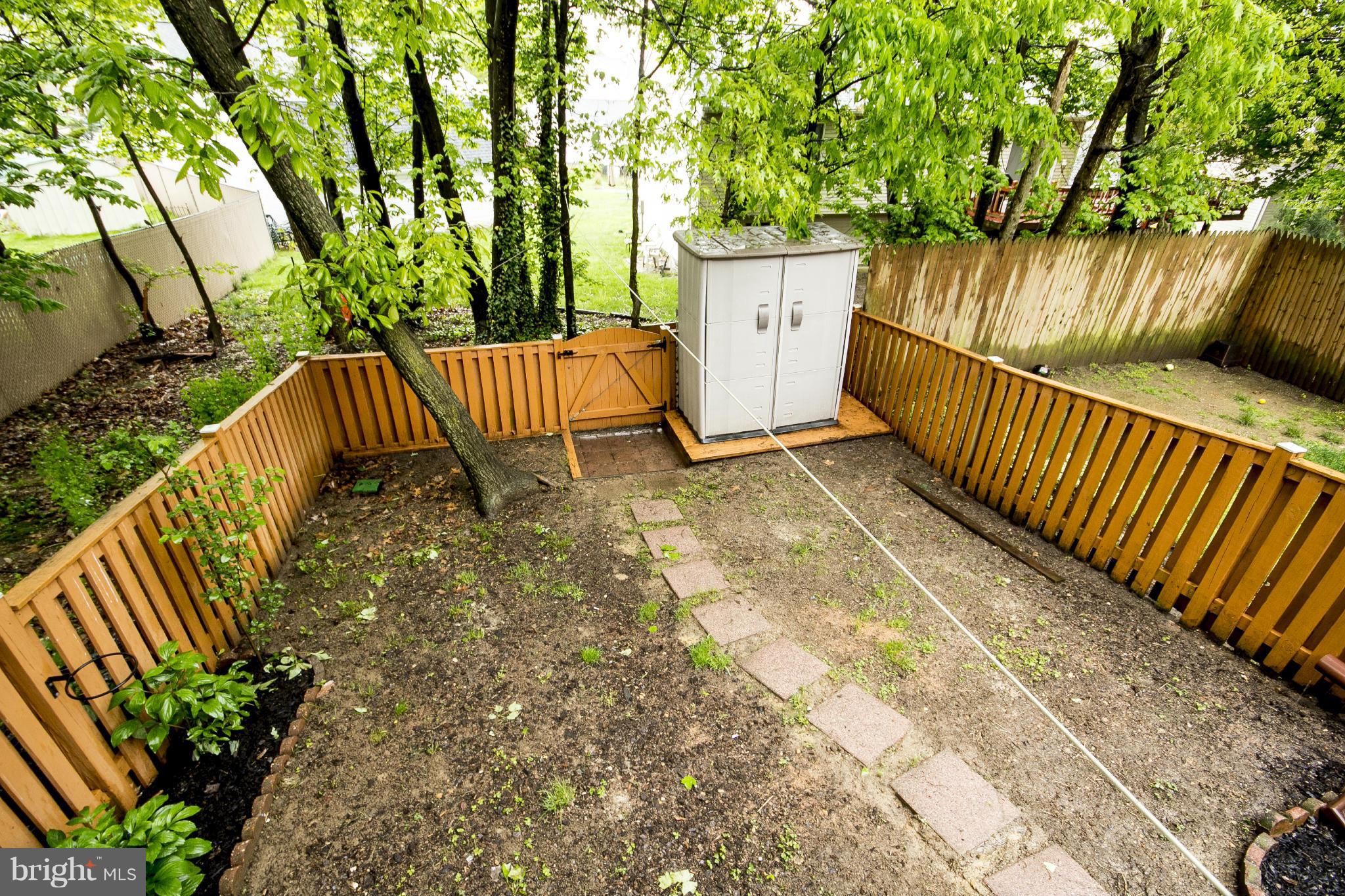 47 Robin Ridge Court Baltimore, MD 21234 - Photo 15 of 30 a view of a backyard with a bench