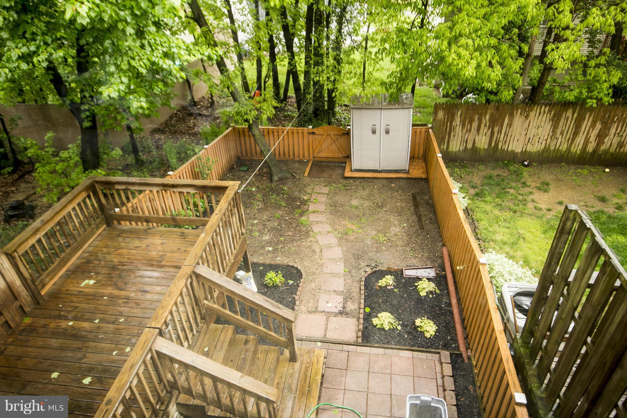 47 Robin Ridge Court Baltimore, MD 21234 - Photo 28 of 30 a view of a balcony with two plants and wooden fence