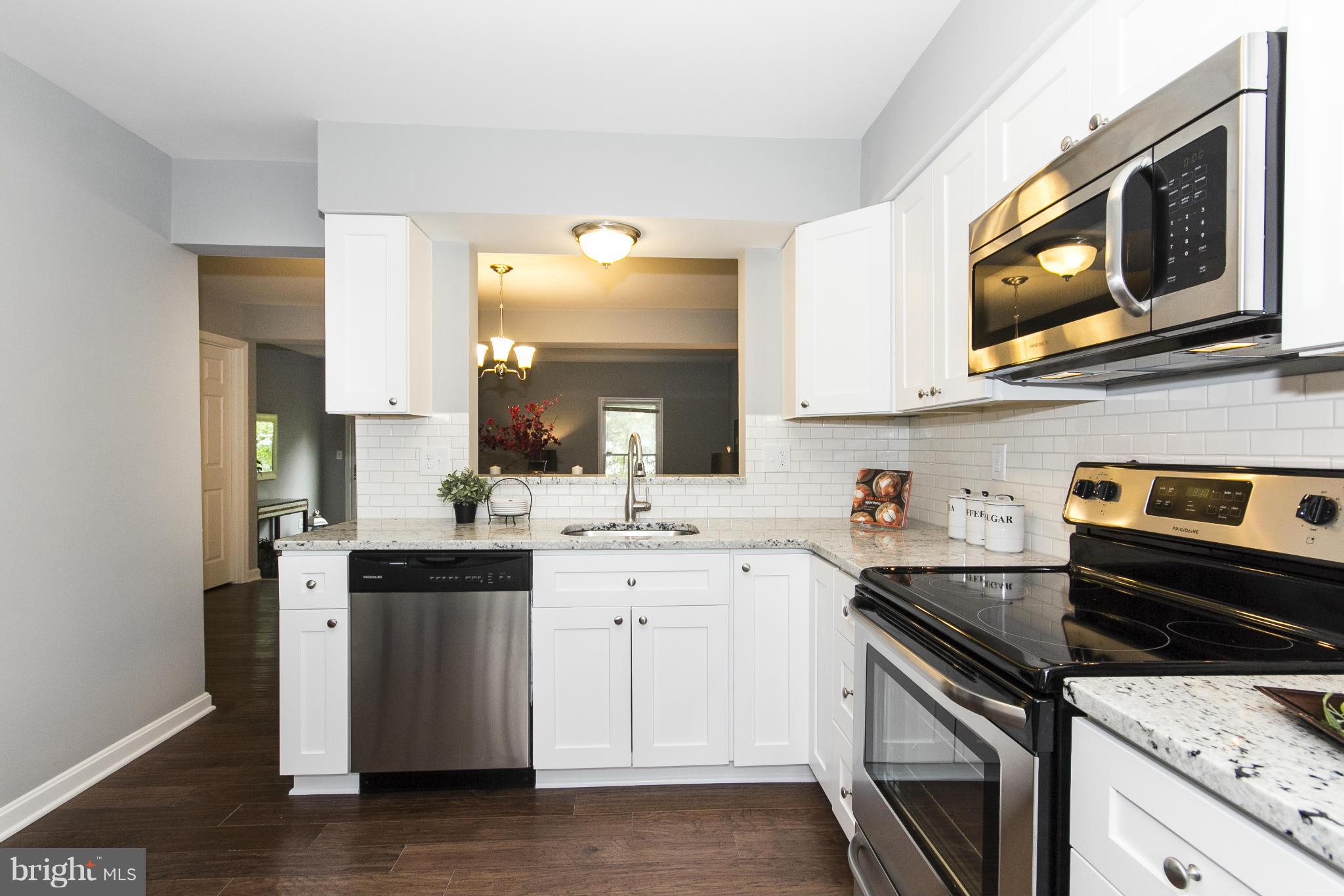 47 Robin Ridge Court Baltimore, MD 21234 - Photo 7 of 30 a kitchen with stainless steel appliances granite countertop a sink stove and microwave