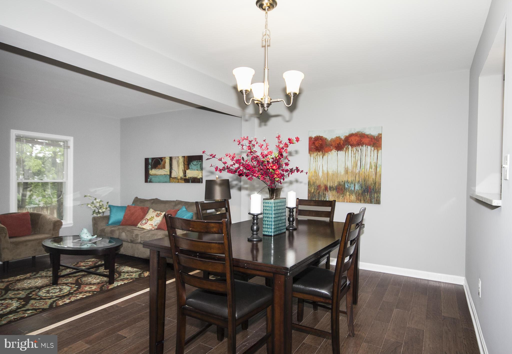 47 Robin Ridge Court Baltimore, MD 21234 - Photo 8 of 30 a view of a dining room with furniture a chandelier and wooden floor