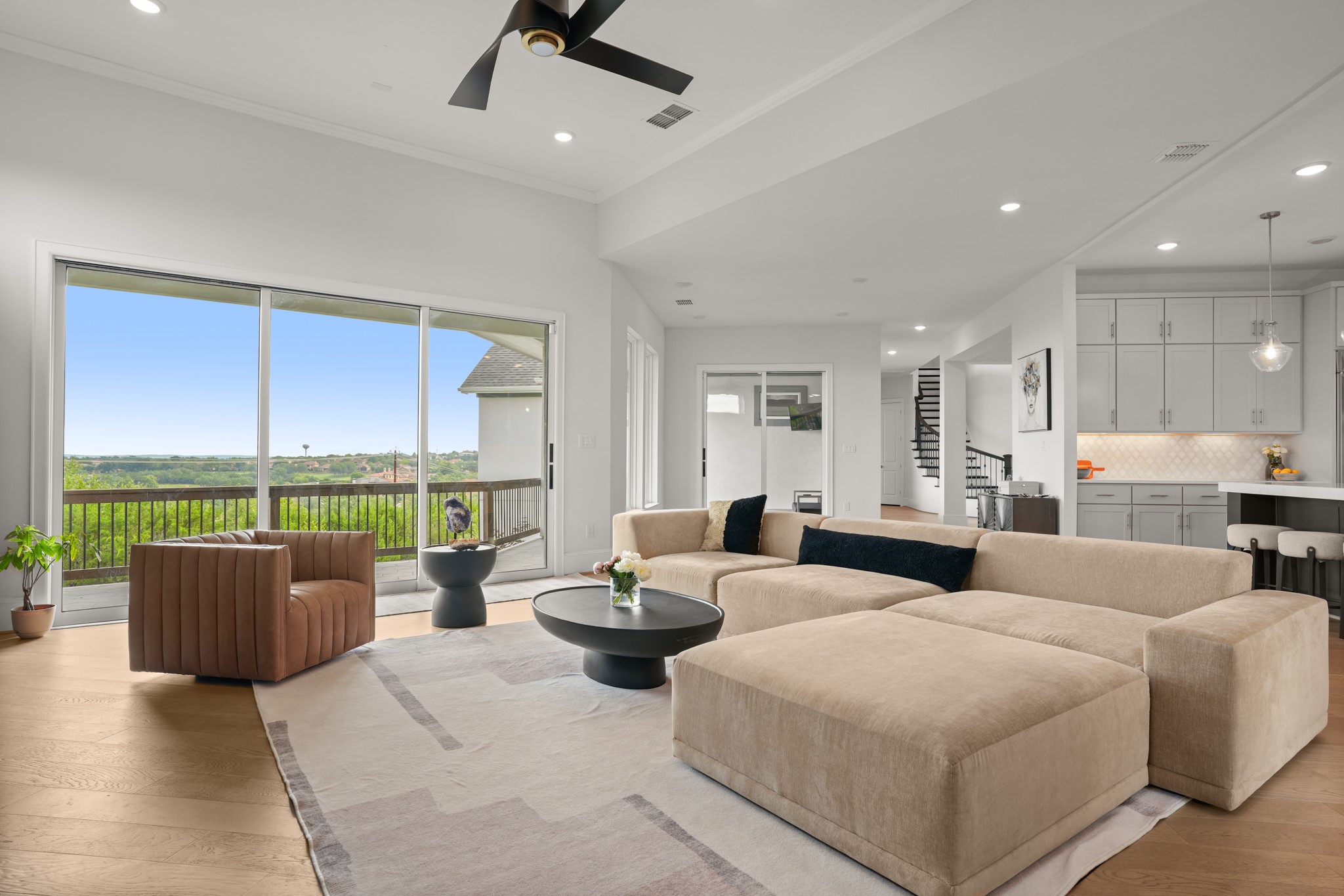 104 Lodestone Cove Austin, TX 78738 - Photo 10 of 40 A spacious living area with hardwood floors, recessed lighting, and a private balcony overlooking verdant landscapes.