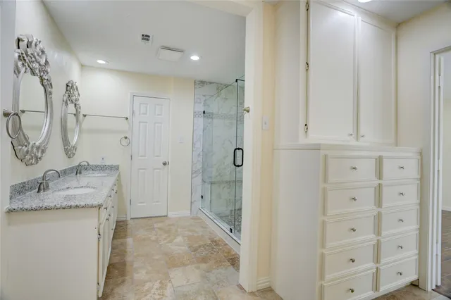 a bathroom with a granite countertop sink a shower and a mirror