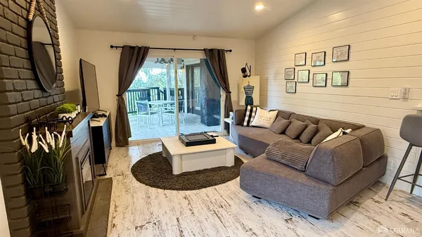 a living room with fireplace furniture and a flat screen tv