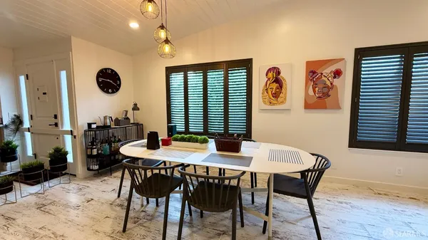 a view of a dining room with furniture and window
