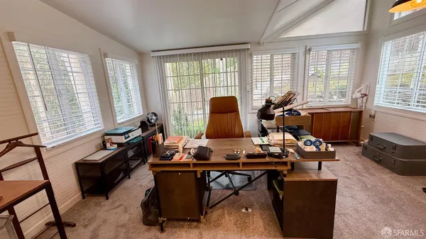 a large bedroom with a bed and a flat screen tv