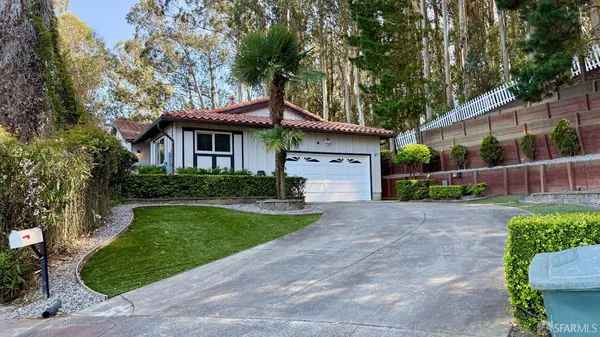 a front view of a house with a yard and a garage