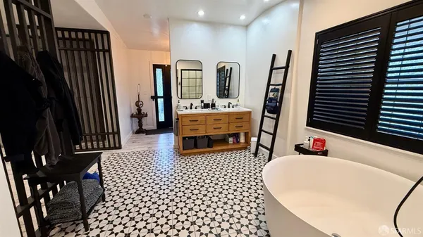 a bathroom with a black and white checkered curtain