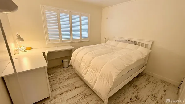 a bedroom with a bed and a table in it