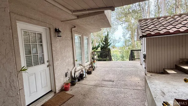 a view of a porch with furniture and a window