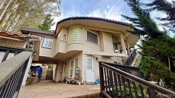 a view of backyard with green space and wooden fence