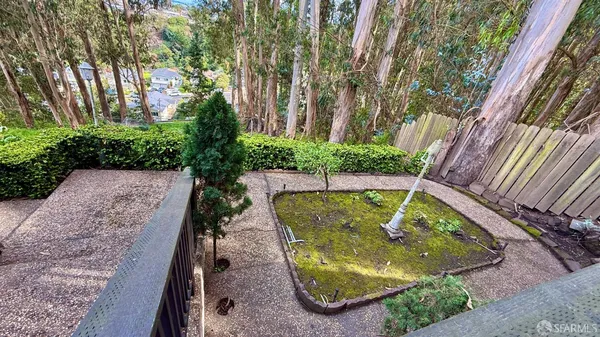 a view of a house with a yard and sitting area