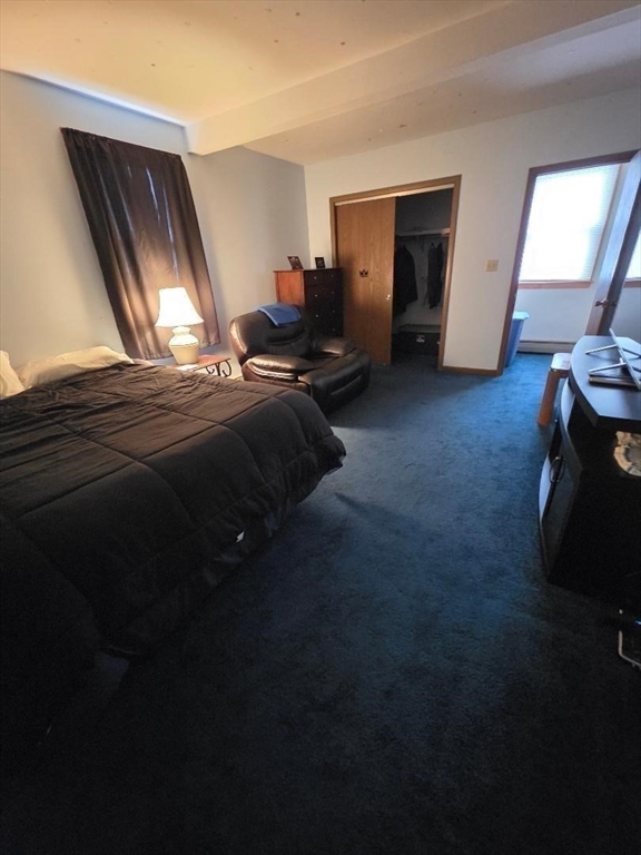 478 Tucker Street Fall River, MA 02721 - Photo 18 of 38 a bed sitting in a room next to a window