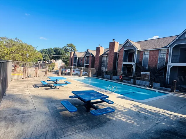 a swimming pool with outdoor seating and yard