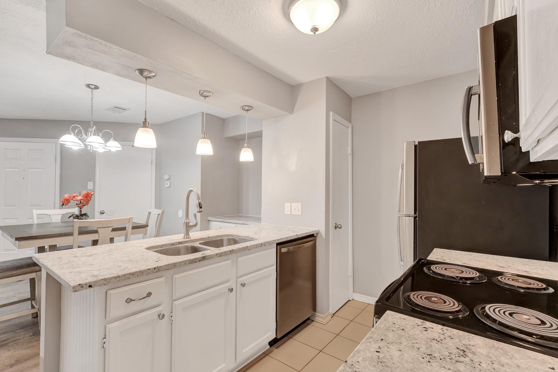 2402 Sycamore Avenue, Unit D4 Huntsville, TX 77340 - Photo 13 of 19 a bathroom with a sink and a mirror