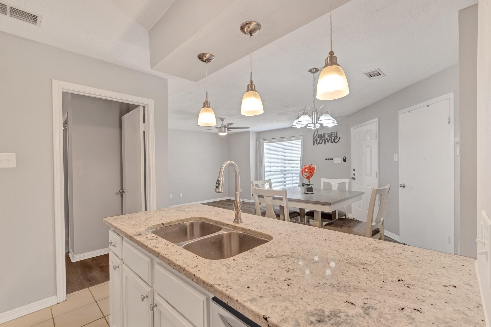 2402 Sycamore Avenue, Unit D4 Huntsville, TX 77340 - Photo 15 of 19 a kitchen with a sink a chandelier and living room view