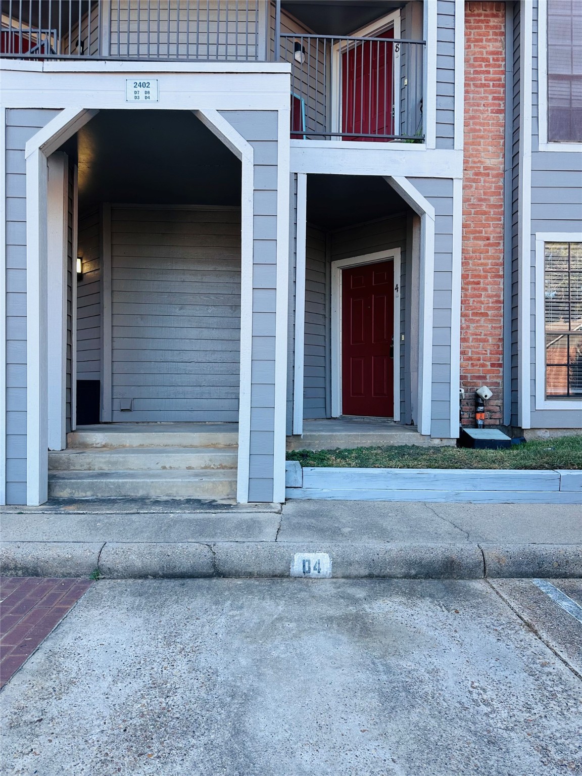 2402 Sycamore Avenue, Unit D4 Huntsville, TX 77340 - Photo 18 of 19 a front view of a house with a yard