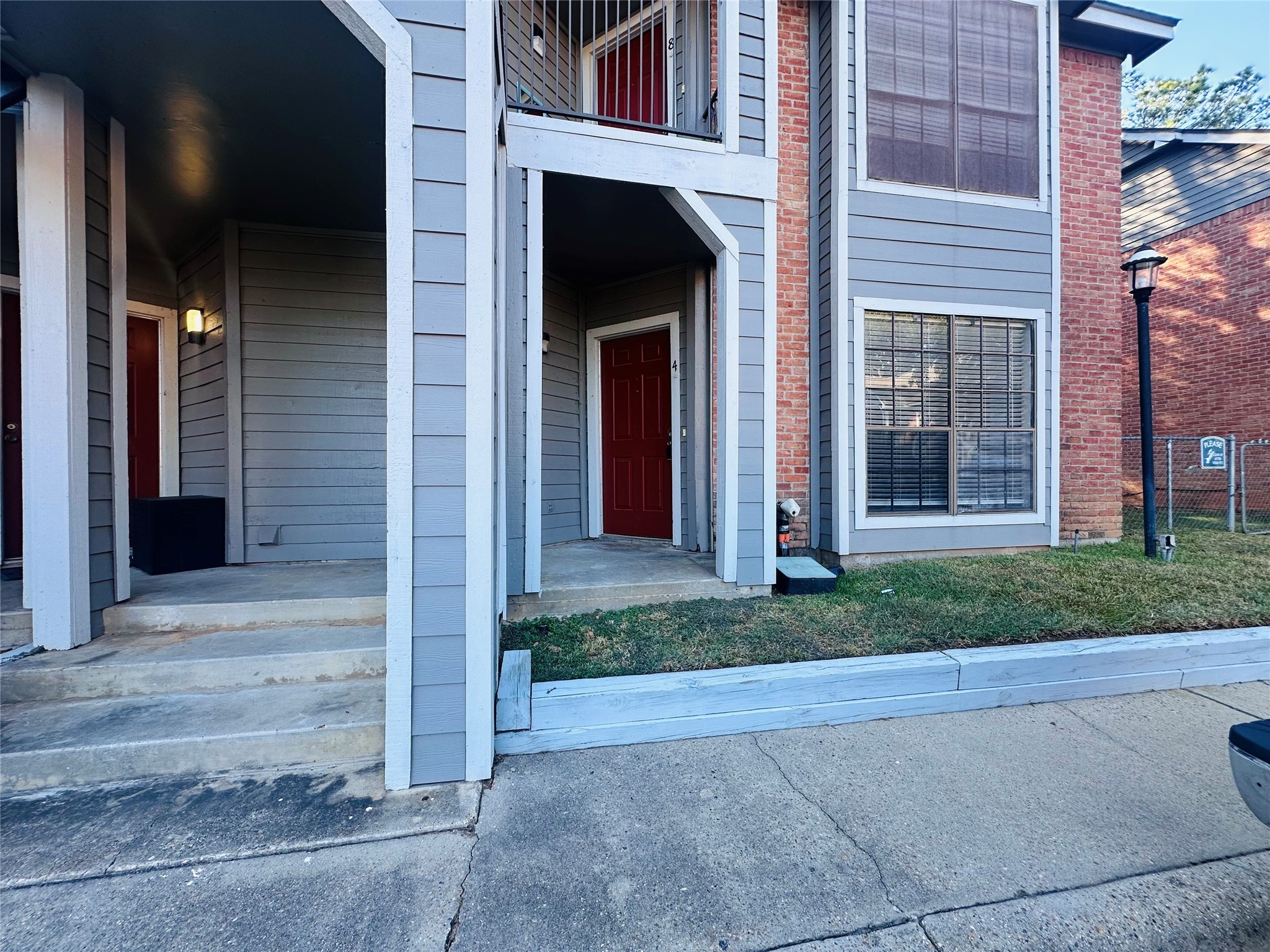 2402 Sycamore Avenue, Unit D4 Huntsville, TX 77340 - Photo 19 of 19 front view of a brick house with a yard