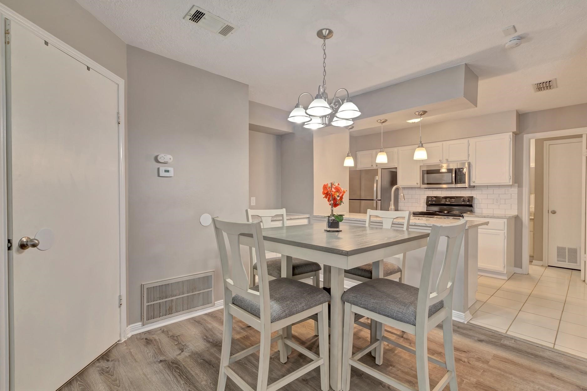2402 Sycamore Avenue, Unit D4 Huntsville, TX 77340 - Photo 4 of 19 a view of a dining room with furniture and chandelier