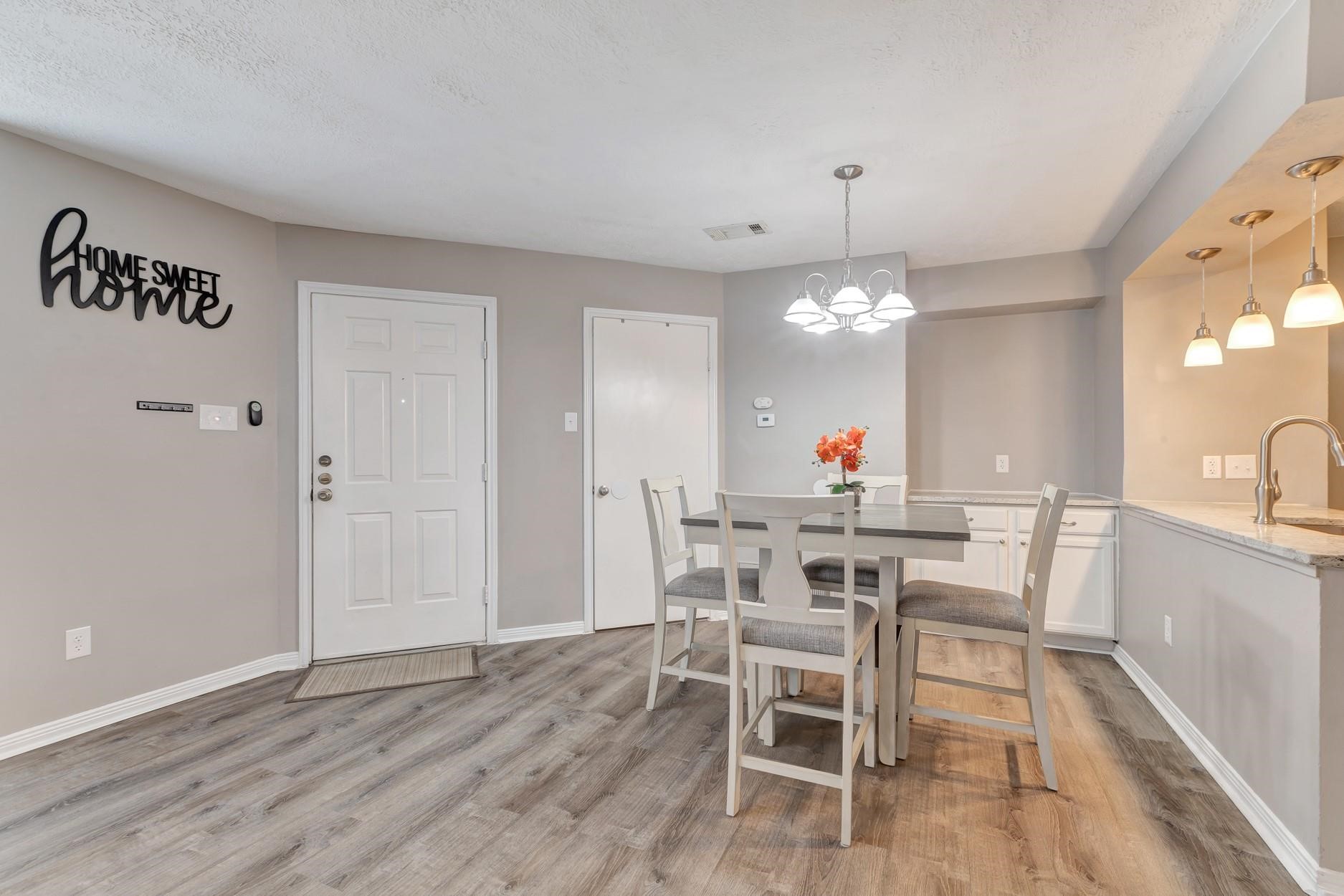 2402 Sycamore Avenue, Unit D4 Huntsville, TX 77340 - Photo 5 of 19 a view of a dining room with furniture and wooden floor