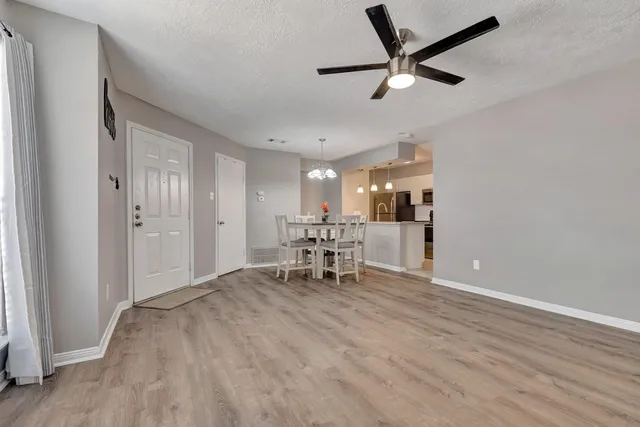 a view of a livingroom with a hardwood floor and a ceiling fan