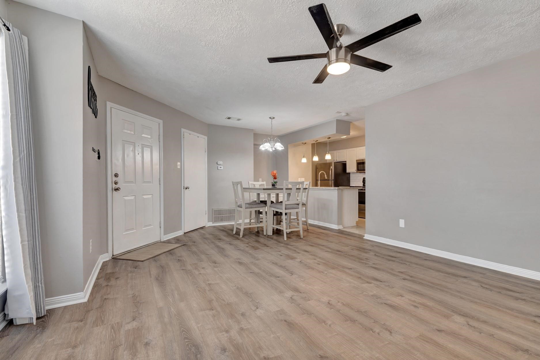 2402 Sycamore Avenue, Unit D4 Huntsville, TX 77340 - Photo 8 of 19 a view of a livingroom with a hardwood floor and a ceiling fan